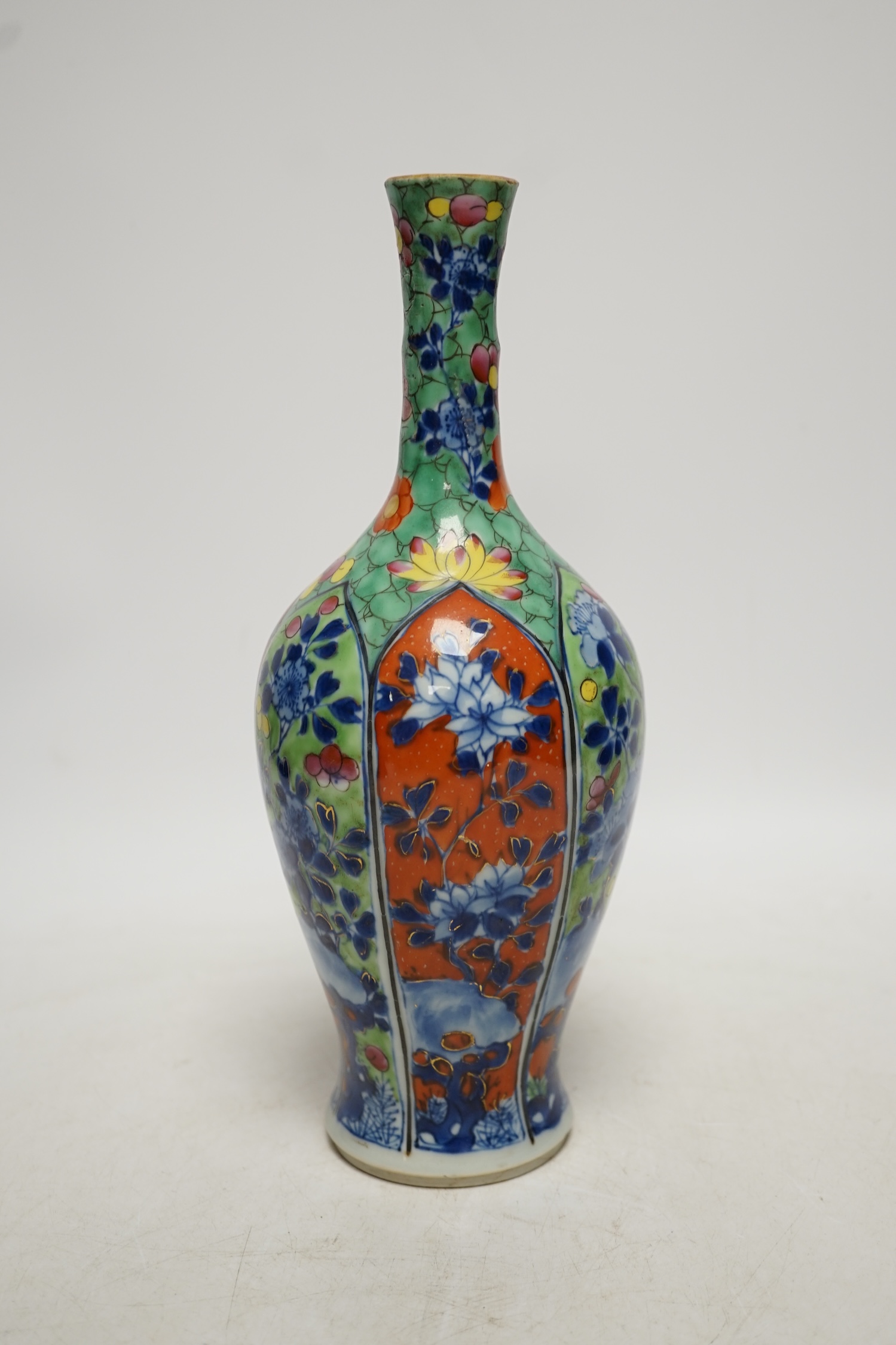 A Chinese clobbered blue and white bottle vase, Kangxi, 26cm high. Condition - ground off rim and hairline crack to neck